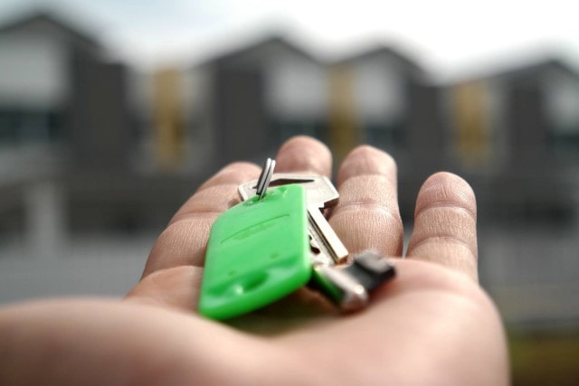 Man holding keys in the palm of his hand