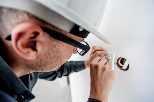 An electrician fitting a wall socket