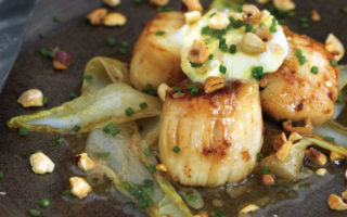 Sautéed scallops with wilted endive, hazelnuts and Sauternes butter