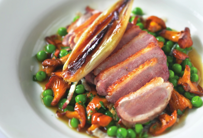 Duck breast with roast shallots, girolles, peas and pancetta