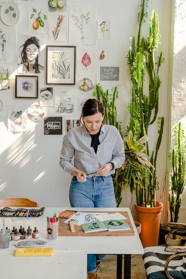 Photo Of Woman Looking At Her Works